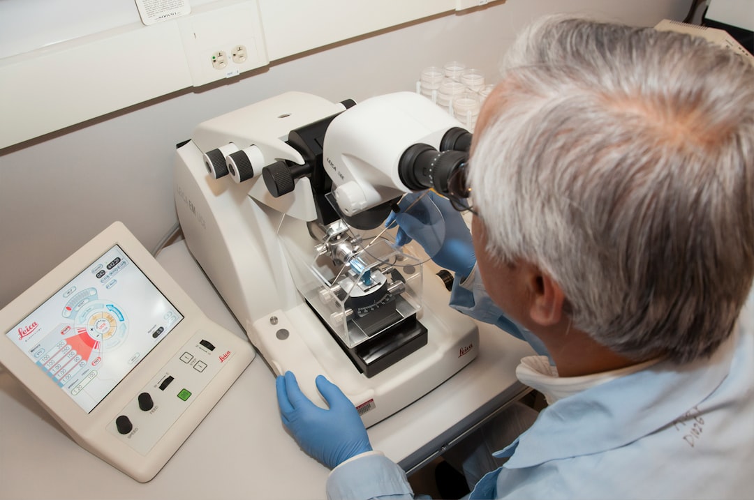 A technician using a microtome at the Advanced Technology Research Facility (ATRF), Frederick National Laboratory for Cancer Research, National Cancer Institute. A microtome is an instrument that cuts extremely thin sections of material for examination under a microscope.